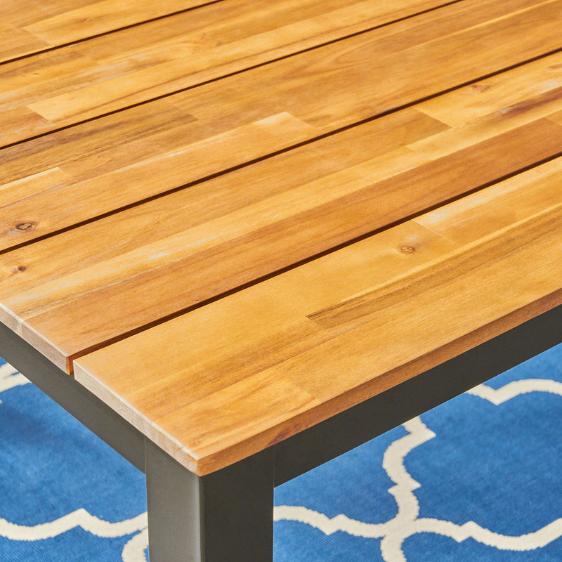 Black rectangular outdoor dining table with iron legs by Noble House, ideal for patio or garden dining setups.