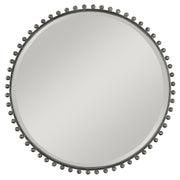 Round iron wall mirror by Uttermost featuring a sleek, modern design with a metal frame and reflective glass surface.