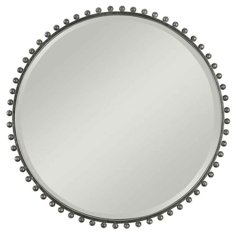 Round iron wall mirror by Uttermost featuring a sleek, modern design with a metal frame and reflective glass surface.