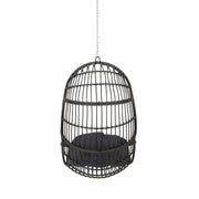 Rustic Noble House hanging basket chair with cushion, featuring woven rattan design and cozy seating for outdoor or indoor relaxation.