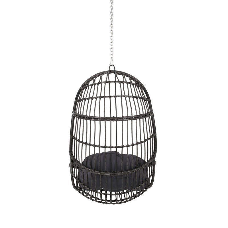Rustic Noble House hanging basket chair with cushion, featuring woven rattan design and cozy seating for outdoor or indoor relaxation.