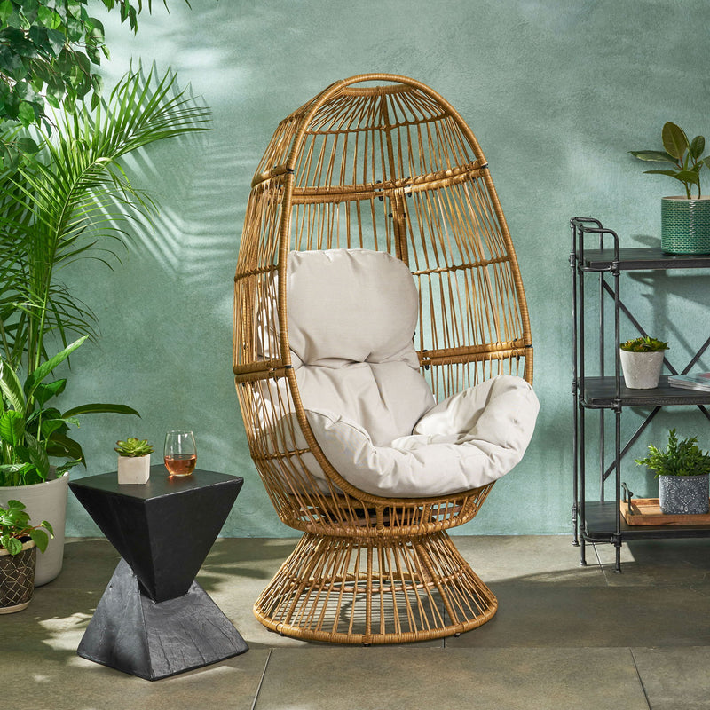 Noble House patio swivel basket egg chair with cushion, outdoor accent seating, featuring woven rattan design and plush cushion.