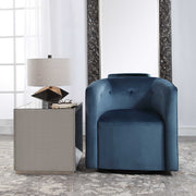 Blue Mallorie swivel chair by Uttermost with a modern design and plush upholstery.