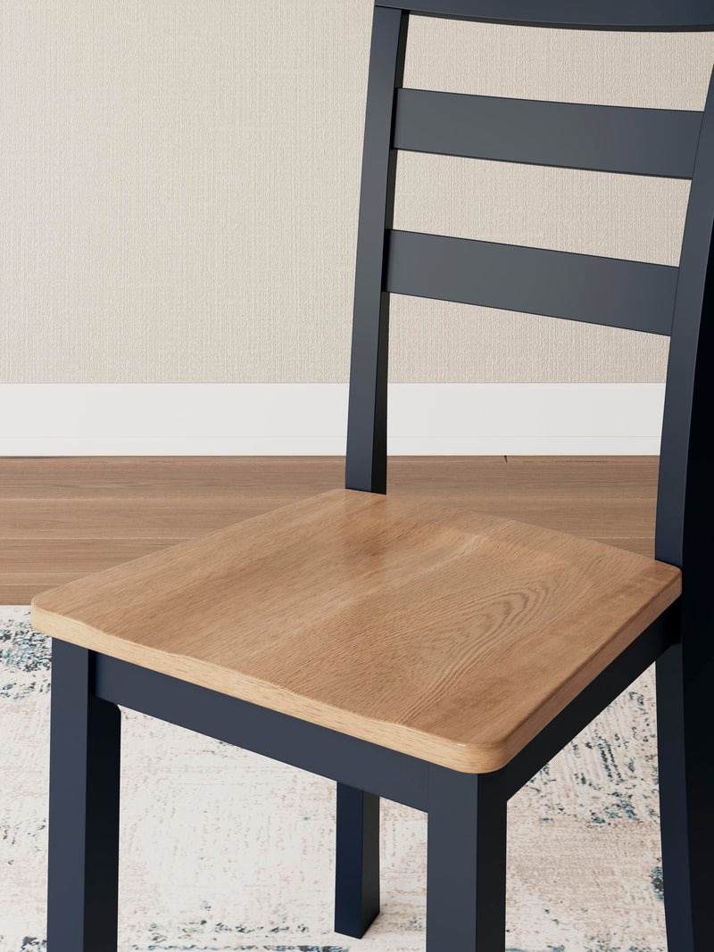 Set of two Signature Design by Ashley Gesthaven dining room side chairs with upholstered seats and wooden legs.
