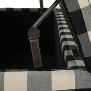 Black Noble House Contemporary Storage Ottoman with cushioned top, serving as seating and hidden storage.