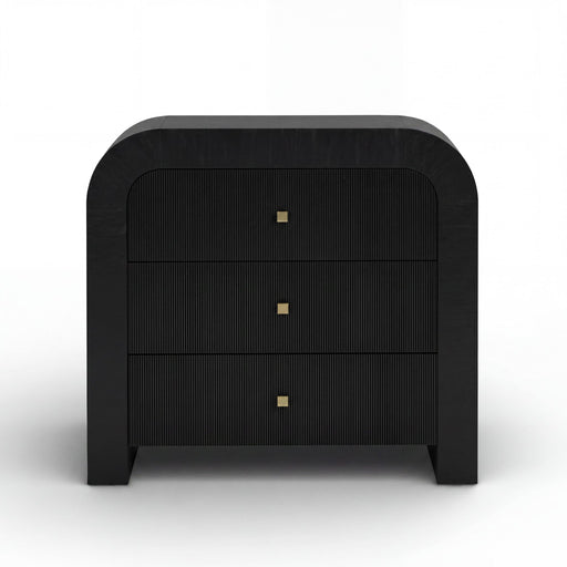 TOV Furniture Hump bedside chest with drawers, wooden finish, and modern design, placed beside a bed in a cozy bedroom setting.
