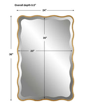 Uttermost Aneta gold scalloped accent mirror with a decorative frame, hanging on a wall with a modern interior background.