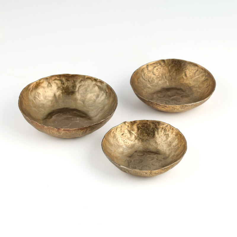 Set of three Shah hammered iron catchall round bowls in antique brass by TOV Furniture, showcasing textured metallic serving bowls.