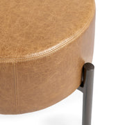 Classic Home Aimie accent stool with a round upholstered seat and wooden legs, ideal for versatile home decor.