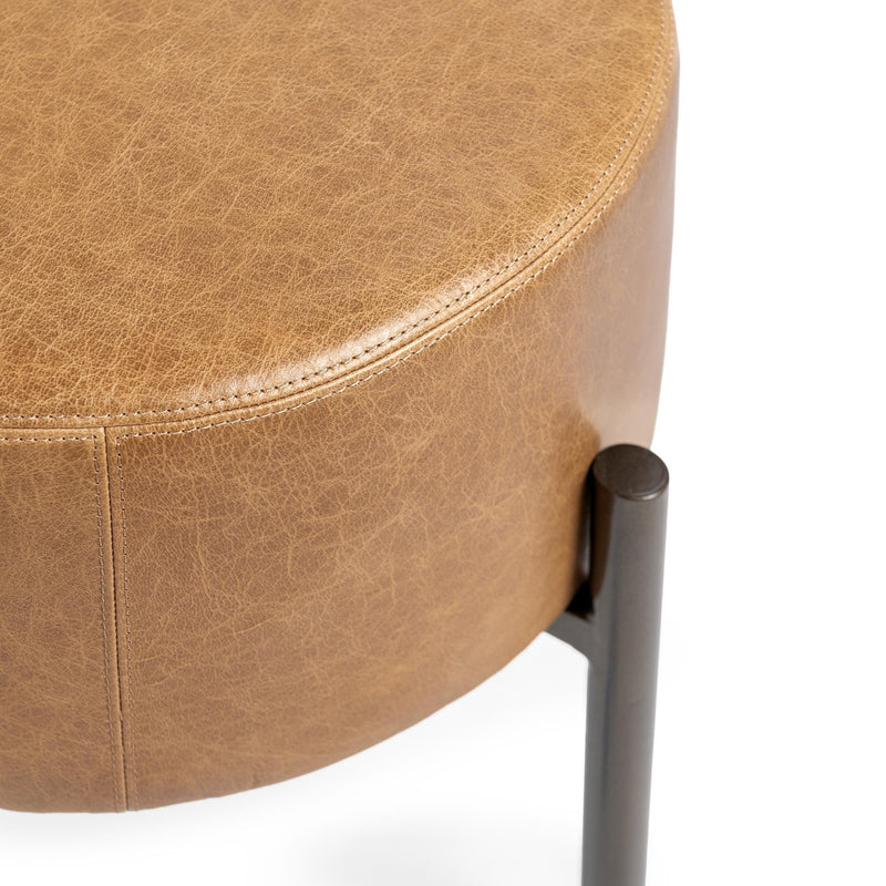 Classic Home Aimie accent stool with a round upholstered seat and wooden legs, ideal for versatile home decor.