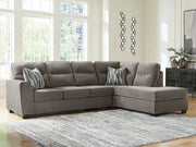 Olten Benchcraft® stationary sectional sofa with plush cushions and modern design, shown in a living room setting.
