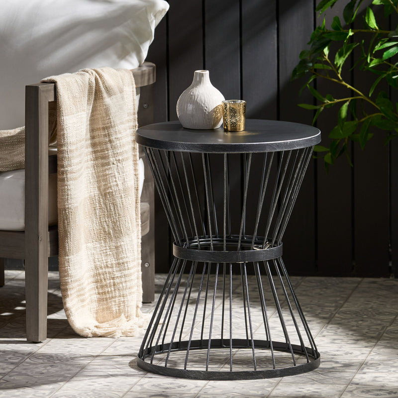 Noble House Lassen modern outdoor side table with hourglass design, featuring sleek metal frame and weather-resistant surface.