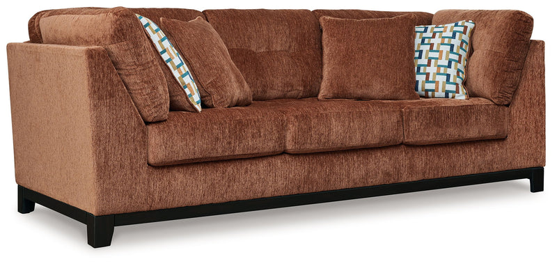 Ashley Laylabrook plush upholstered sofa in bold spice color with dark wood trim, perfect for a stylish living room.