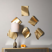 Set of six gold Fluttering Pages wall decor by Uttermost, featuring abstract, feather-inspired designs for modern interior decoration.