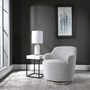 Gray Uttermost Hobart casual swivel chair with a modern design and cushioned seat, featuring a rounded back and sleek base.