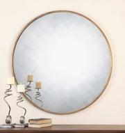 Uttermost Junius round wall mirror with a sleek, modern frame hanging on a wall, ideal for contemporary home decor.