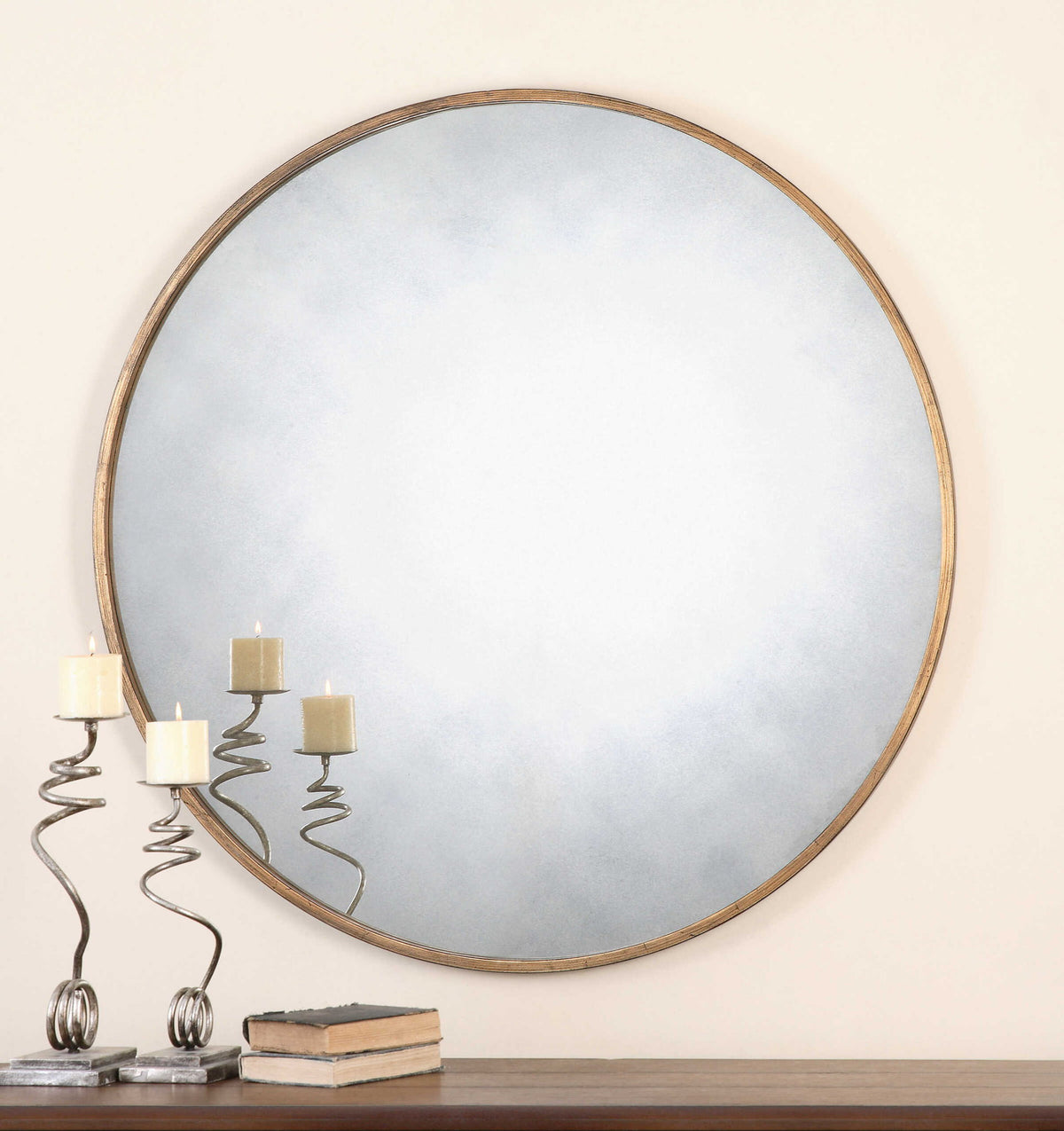 Uttermost Junius round wall mirror with a sleek, modern frame hanging on a wall, ideal for contemporary home decor.