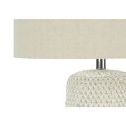 Cream ceramic and resin contemporary table lamp by 8th Street, featuring a sleek modern design and soft ambient lighting.