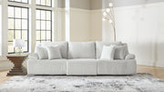 Signature Design by Ashley reclining sectional with plush cushions and reclining seats in a modern living room setting.