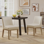 Set of two Noble House modern dining chairs with durable fabric upholstery and sturdy wooden frames, shown from a front angle.