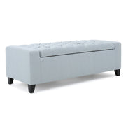 Noble House Guernsey storage ottoman with tufted top, beige fabric, and wooden legs, used as a versatile living room furniture piece.