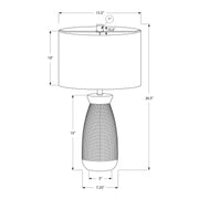 Contemporary cream ceramic and resin table lamp by 8th Street, featuring a sleek, modern design with a white lampshade.