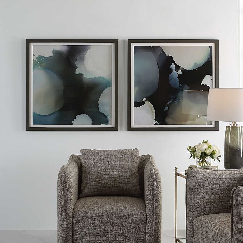 Set of two black framed abstract prints with telescopic design by Uttermost, displayed on a wall.