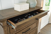 Medium brown Karallin Seven Drawer Chest from Signature Design by Ashley®, with sleek accent chest design and silver handles.