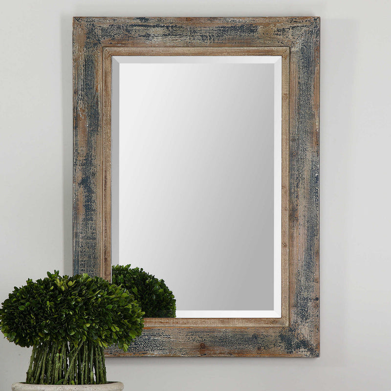 Distressed blue wall mirror from Uttermost's Bozeman collection, featuring a rustic, textured frame perfect for farmhouse decor.