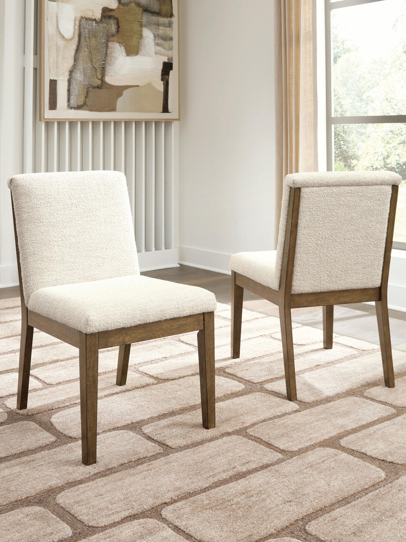 Set of two Benchcraft Marxmore dining upholstered side chairs in beige and brown with cushioned seats and wooden legs.
