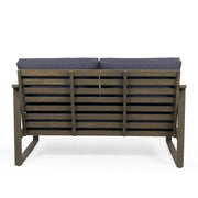 Noble House Samwell outdoor 2-piece coffee table and loveseat set with woven rattan design and neutral cushions.