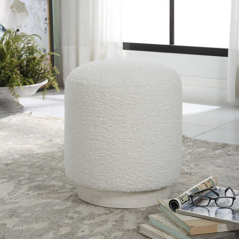 Uttermost Avila accent ottoman with a plush upholstered top and decorative wooden legs, ideal for living room or bedroom decor.