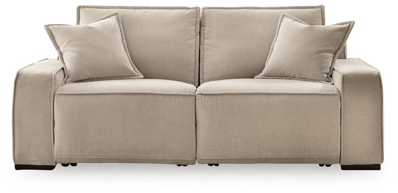 Benchcraft® Carceri reclining sectional with plush cushions, neutral fabric upholstery, and multiple reclining seats in a modern living room setting.