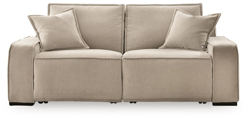 Benchcraft® Carceri reclining sectional with plush cushions, neutral fabric upholstery, and multiple reclining seats in a modern living room setting.