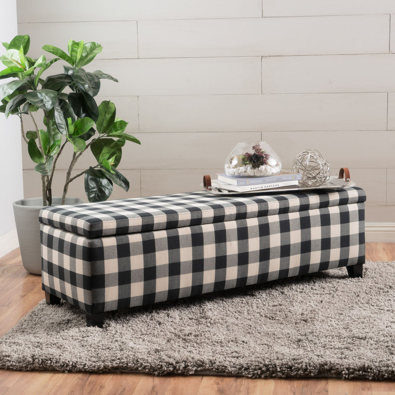 Black Noble House contemporary storage ottoman with padded seating and hidden storage compartment.