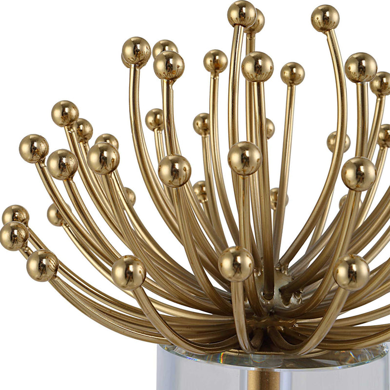 Set of two modern gold sculptures by Uttermost featuring abstract, sleek design for contemporary decor.