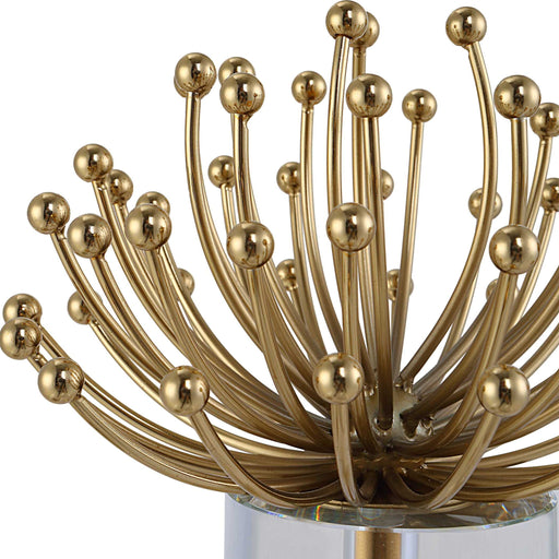 Set of two modern gold sculptures by Uttermost featuring abstract, sleek design for contemporary decor.