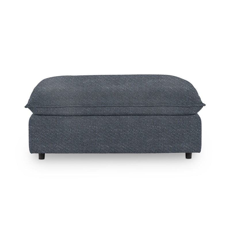 Classic Home Caplan upholstered ottoman with a cushioned top and wooden legs, ideal for living room or bedroom decor.