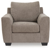 Benchcraft® arm chair with plush upholstery and wooden legs, featuring a contemporary design and comfortable seating.