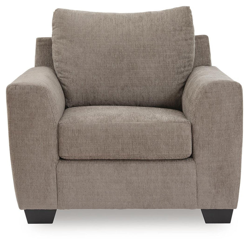 Benchcraft® arm chair with plush upholstery and wooden legs, featuring a contemporary design and comfortable seating.