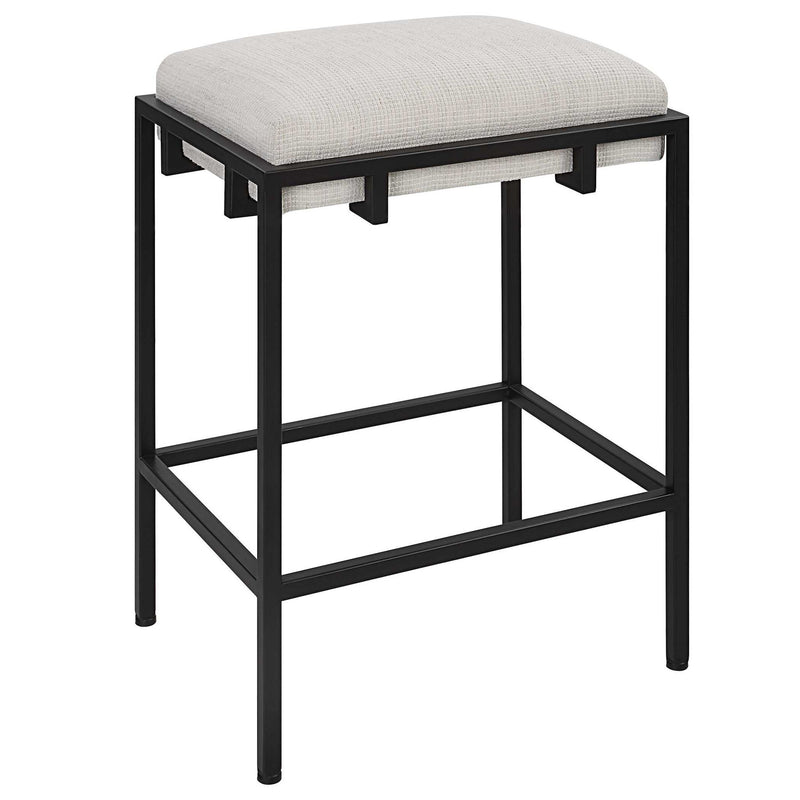 White Paradox counter stool by Uttermost with a sleek design and wooden legs, suitable for kitchen or bar counter seating.