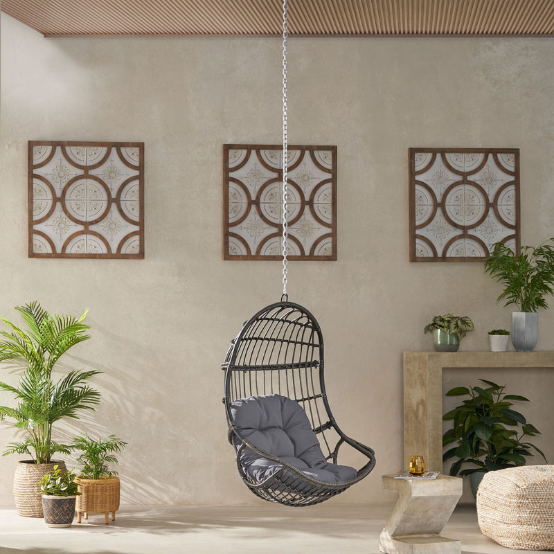 Rustic Noble House hanging basket chair with cushion, suspended with rope, ideal for indoor or outdoor relaxation.