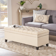 Noble House Juliana storage ottoman with beige fabric and birch wood legs, featuring a cushioned top and interior storage space.