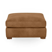 Classic Home Audrey upholstered ottoman with a plush fabric top and wooden legs, ideal as a stylish footrest or accent piece.