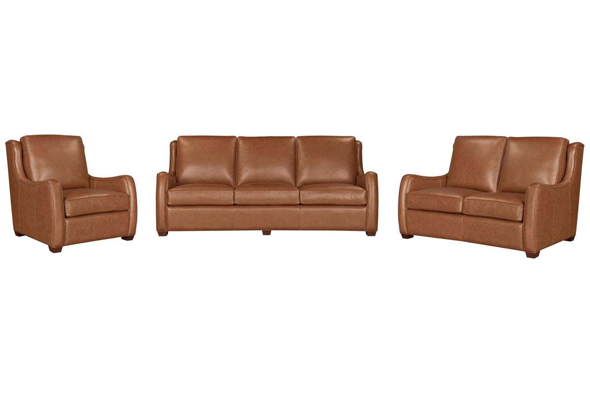 Two-piece Channing leather living room set with scroll arms and antique brass nail trim in Renaissance Cinnamon color.