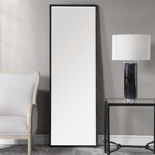 Uttermost Callan Leaner Mirror in black with sleek modern frame, standing tall against a neutral background.
