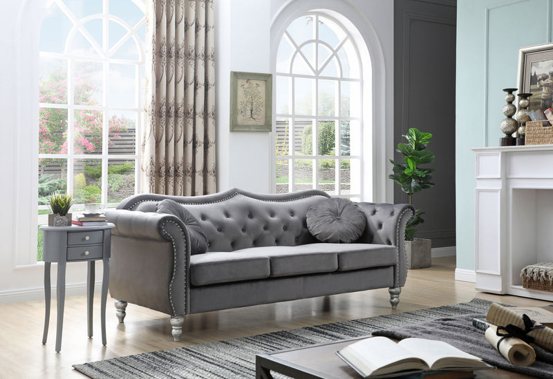 Glory Furniture Hollywood stationary sofa with plush beige upholstery and modern design, shown in a stylish living room setting.
