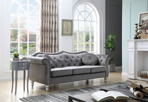Glory Furniture Hollywood stationary sofa with plush beige upholstery and modern design, shown in a stylish living room setting.