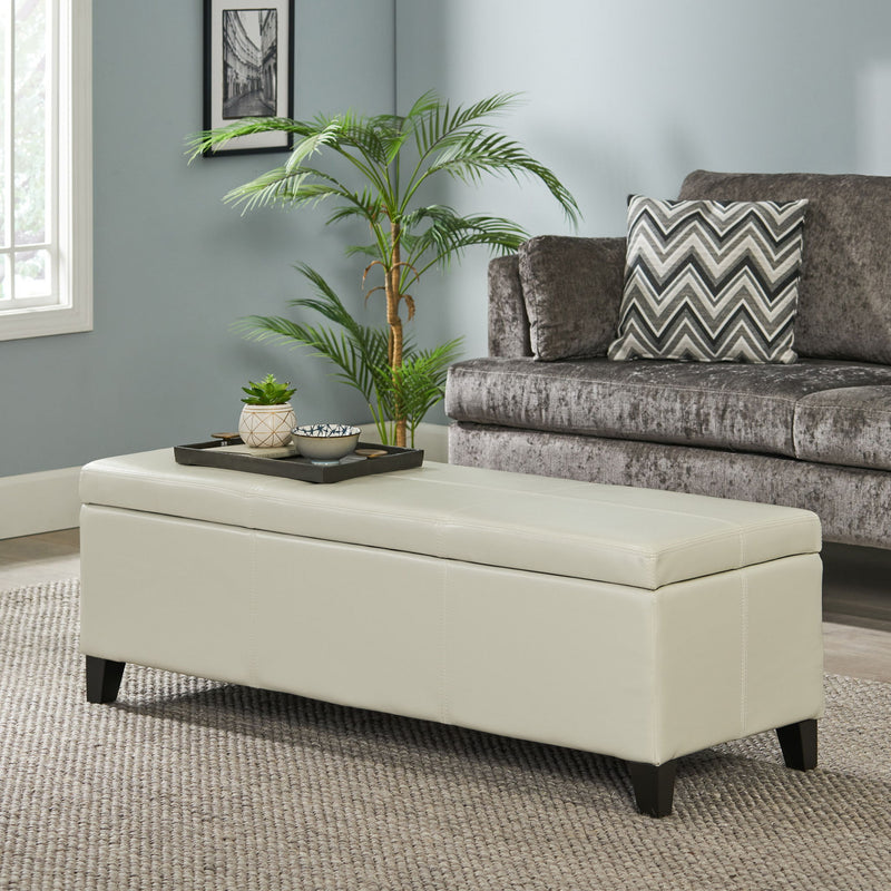 Noble House Glouster contemporary storage ottoman with beige fabric upholstery and wooden legs, serving as a stylish storage solution.