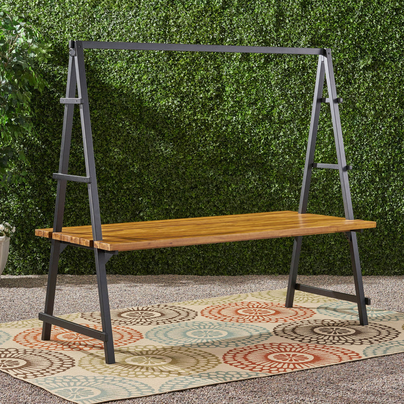 Noble House Huckleberry outdoor dining table in teak with acacia wood finish and built-in plant hanger, perfect for patio dining.